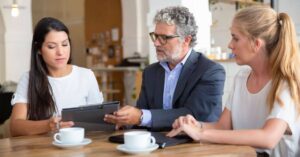 man showing information on a clipboard to a woman