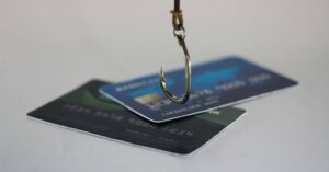 (fishing hook over credit cards)
