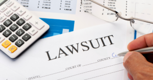 person filling out a lawsuit document