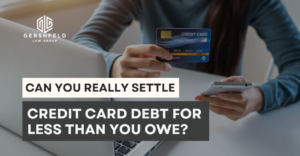 A person holding a credit card and a smartphone, with the Gershfeld Law Group logo and the text “Can You Really Settle Credit Card Debt for Less Than You Owe?”
