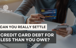 A person holding a credit card and a smartphone, with the Gershfeld Law Group logo and the text “Can You Really Settle Credit Card Debt for Less Than You Owe?”