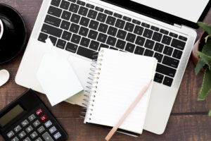 Laptop, calculator, and financial documents illustrating credit and debt planning.