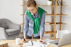Person reviewing expenses and budgeting at home