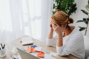 Person stressed about debt and financial bills